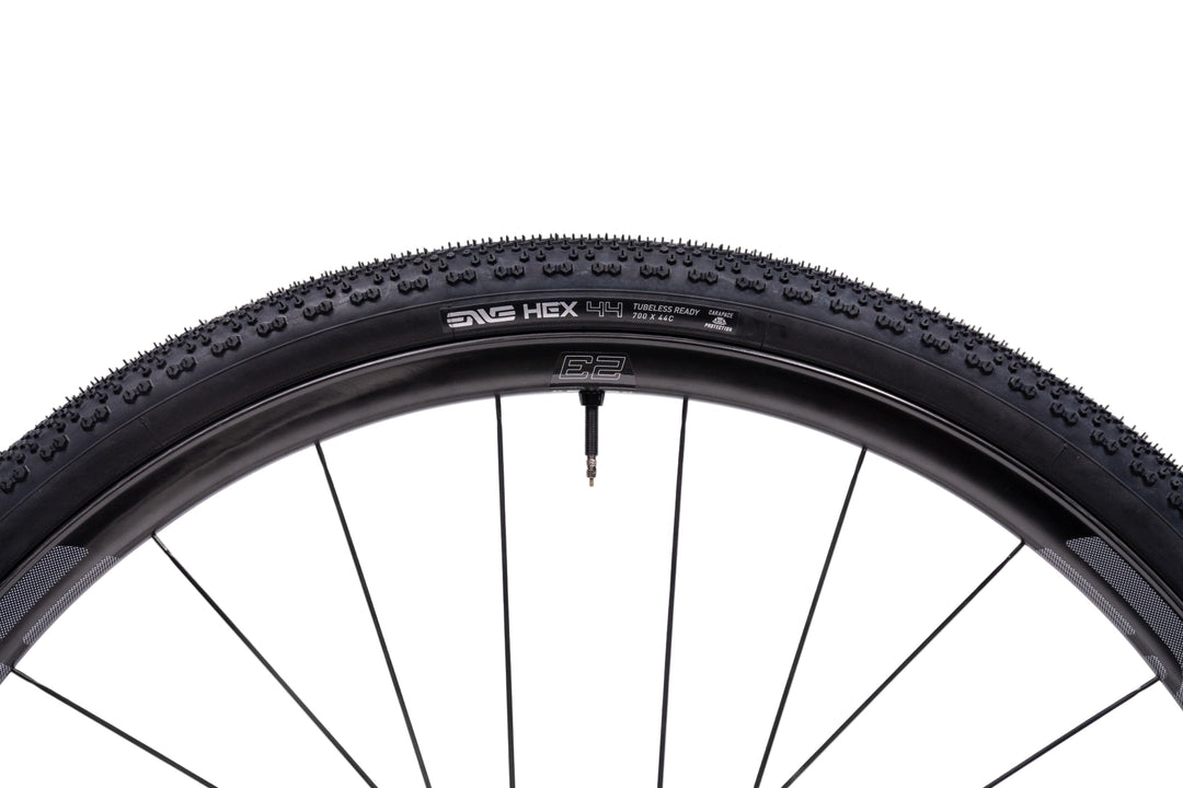 Bicycle tire with tread pattern and brand name on a white background