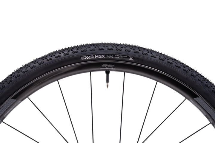 Bicycle tire with tread pattern and brand name on a white background